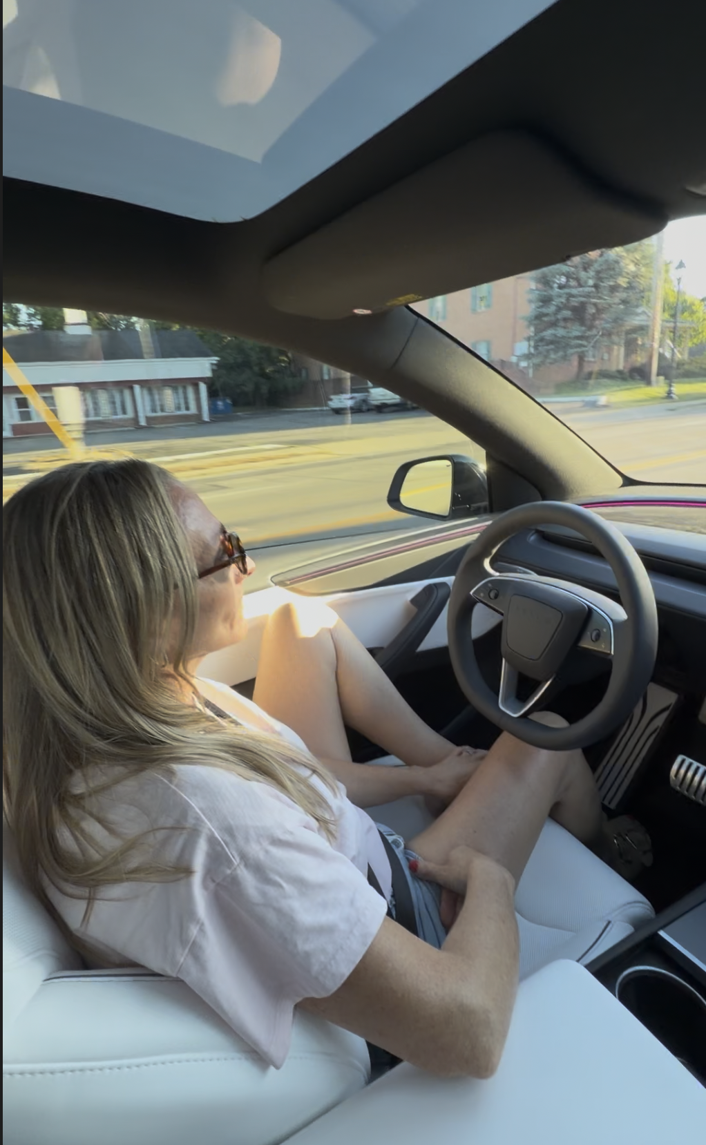 Passenger inside a Tesla Model Y Performance while Full Self-Driving is active on a city street