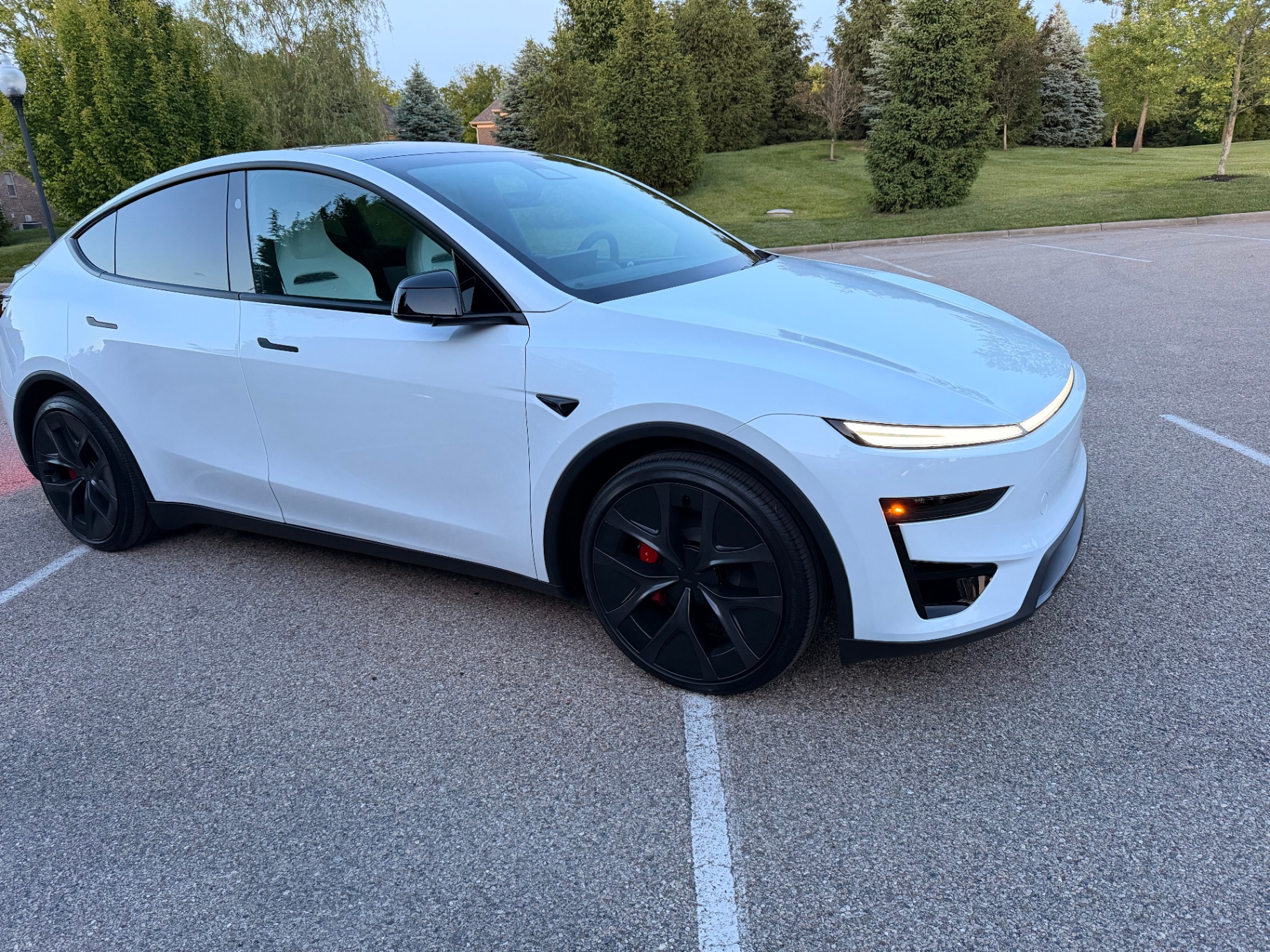 White 2026 Tesla Model Y Performance parked at dusk in an Ohio lot, front three-quarter view