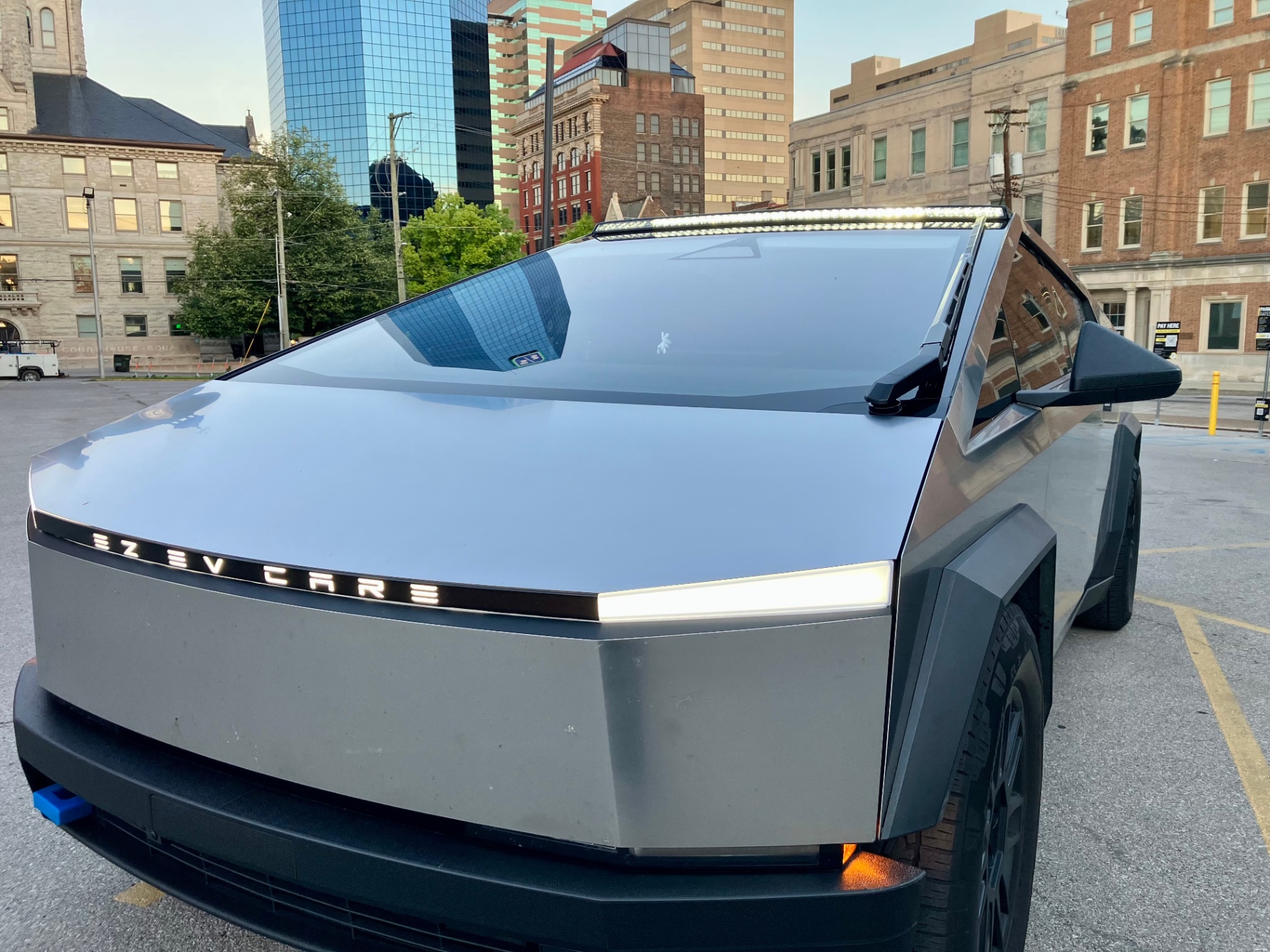 Tesla Cybertruck front three-quarter showing EZ EV Care branding