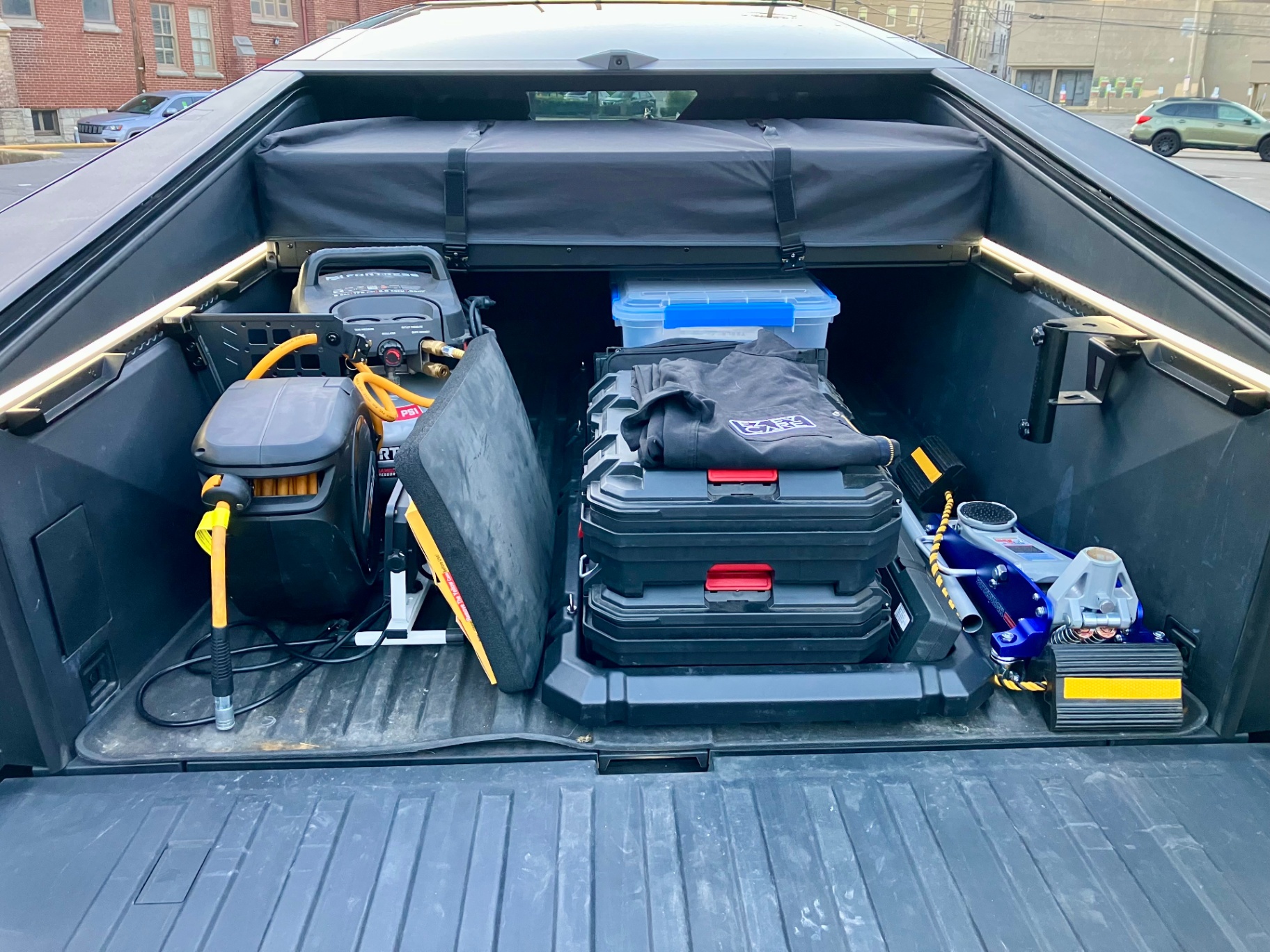 Tesla Cybertruck bed loaded with mobile EV service tools and equipment